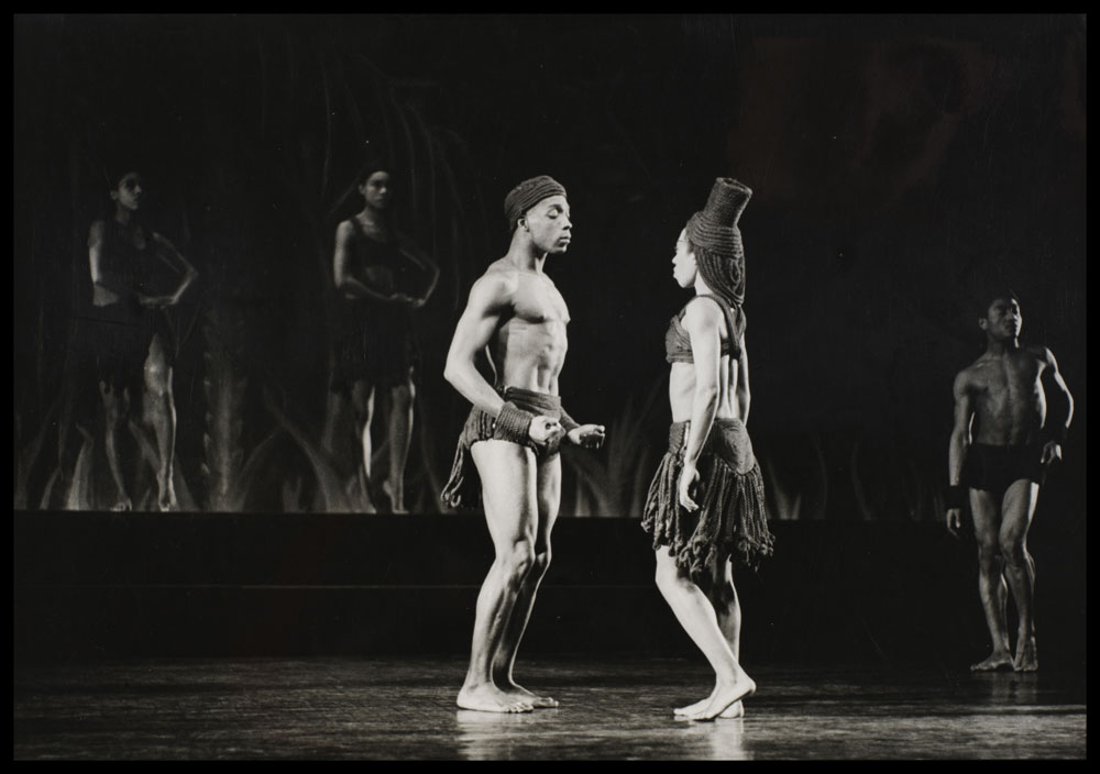 Black and white photograph of performers on stage in Rites de Passage- A Caribbean Rhapsody