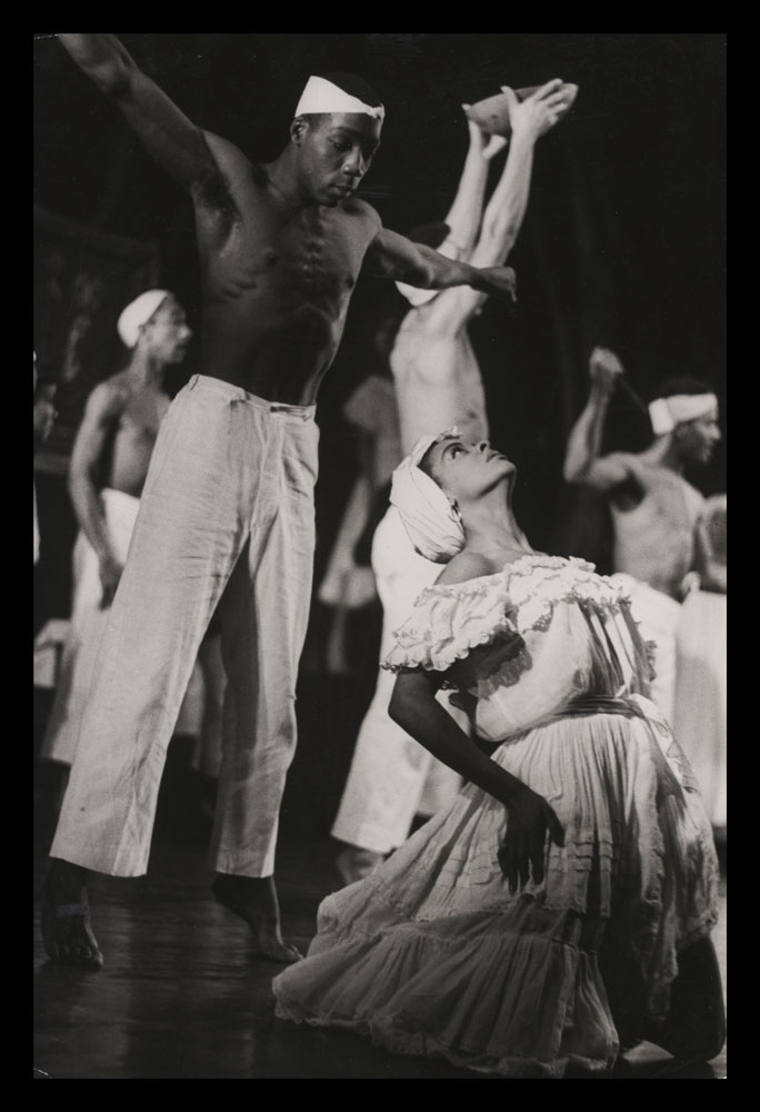 Black and white photograph of performers on stage in Shango-A Caribbean Rhapsody