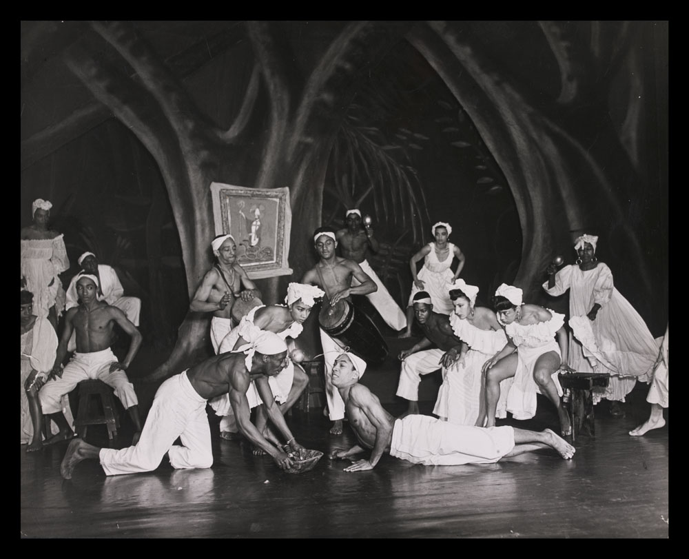 Black and white photograph of performers on stage in Shango-A Caribbean Rhapsody