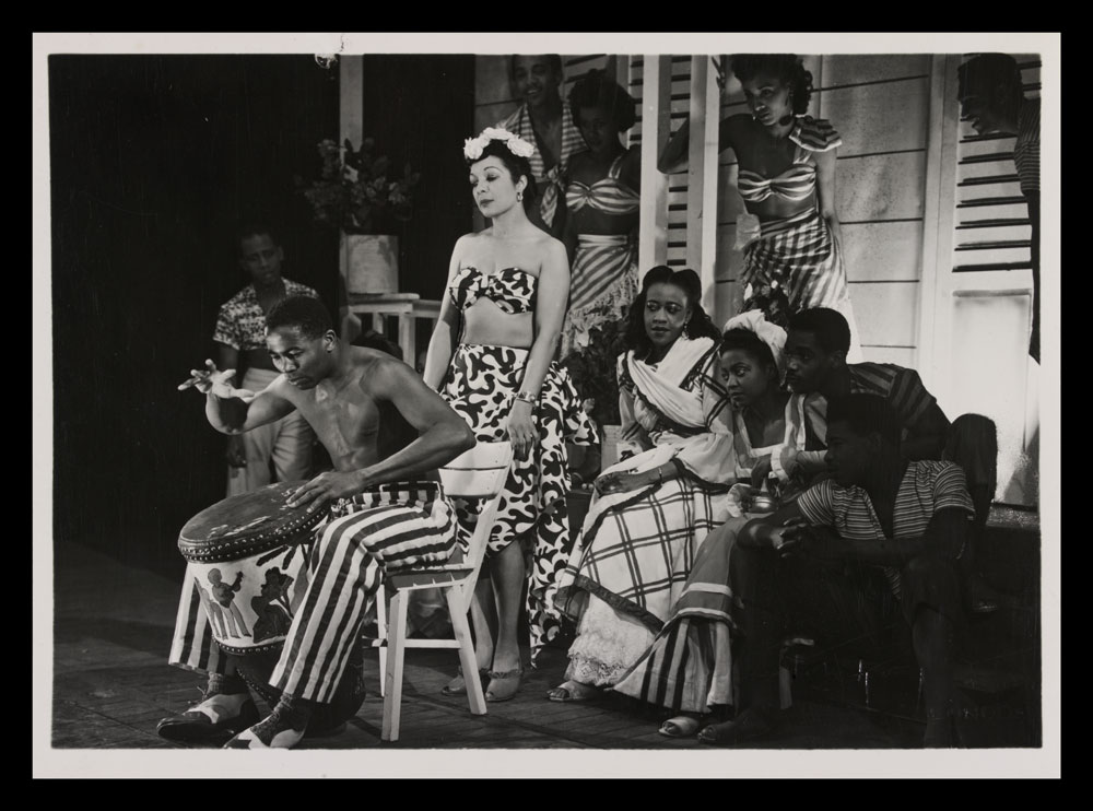 Black and white photograph of actors on stage in Calypso