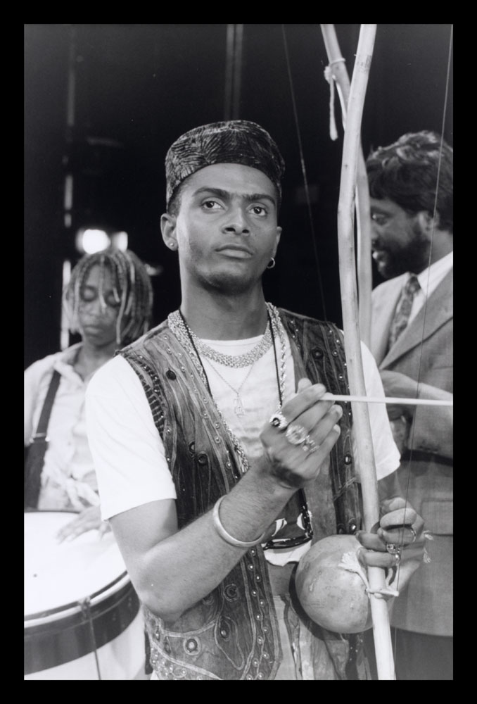 B&W photo of man with stringed instrument from Zumbi